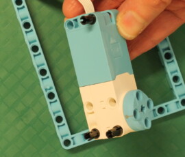 Mount motor to frame with three black pins.